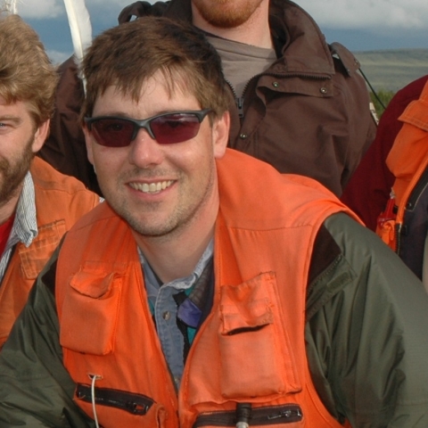 Man wearing orange safety float vest