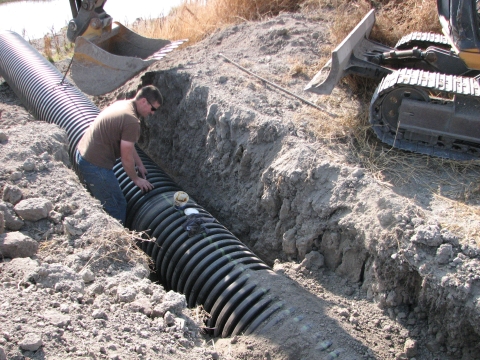 FWS Staff Installing Drain Pipe at Tule Lake NWR