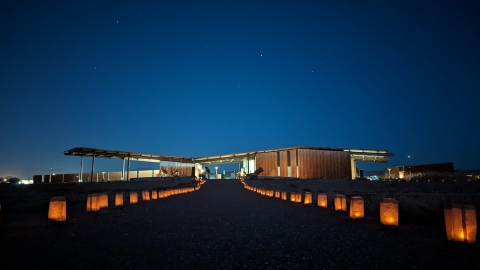 A lighted path leading up to the entrance of a building