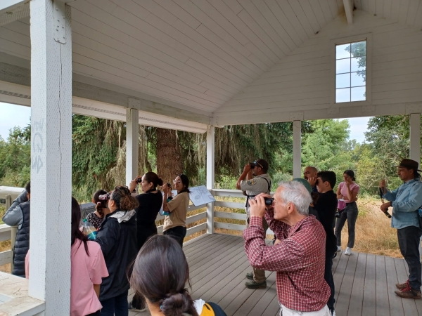 Families and staff looking through binoculars