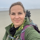 photo of Jenny on the beach with binoculars and spotting scope