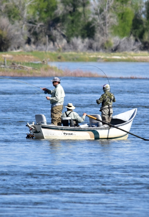 3 people in boat fishing