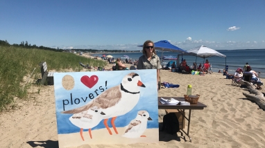 Intern conducts public outreach event at Rachel Carson NWR on a beach in Maine.