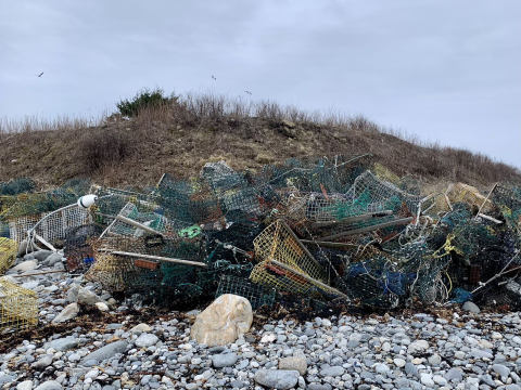 colorful wire boxes litter the rocky shore