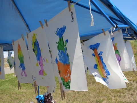 Colorful fish art hanging up to dry. 