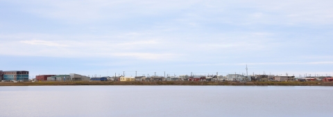 View across a large pond of many colorful buildings