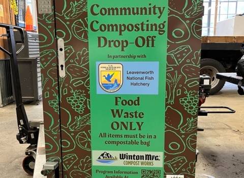 a green and brown metal container reads "communtiy composting drop-off"