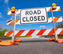 Road closed sign blocking of a road