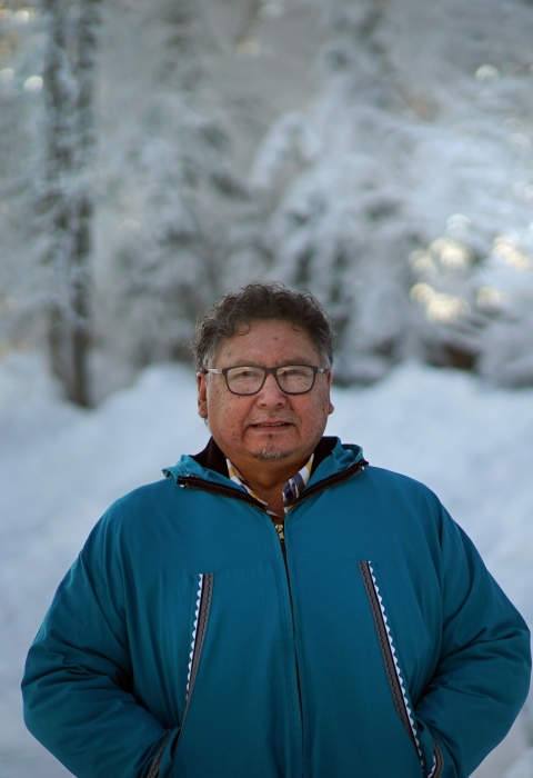 a man in blue standing next to snow