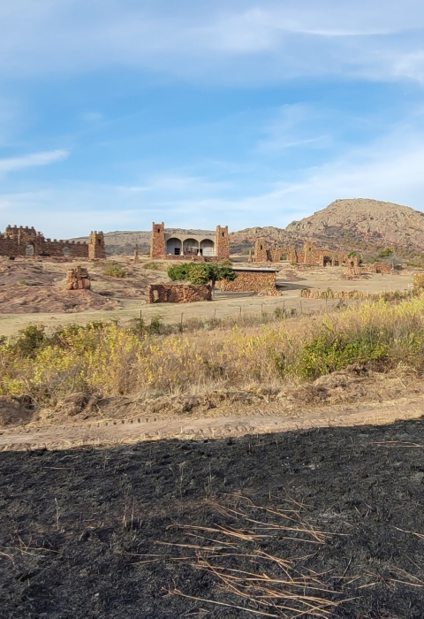 The Holy City, located within Wichita Mountains Wildlife Refuge, with charred black grass in the foreground. 