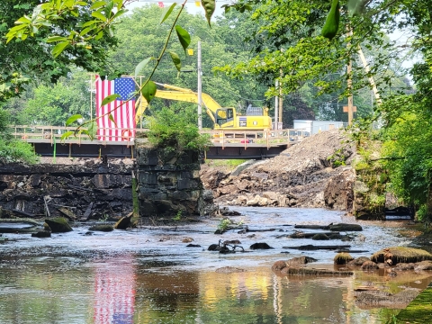 A river passes through a partially deconstructed dam