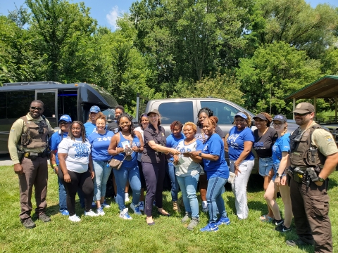 group stand outside, many wearing Zeta blue