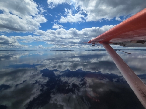 aerial view of lake with plane wing 