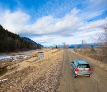 A vehicle drives a dirt road