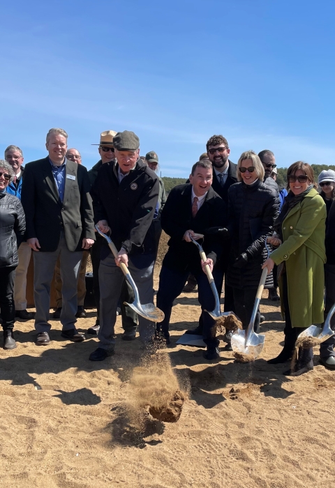 A group of people with shovels 
