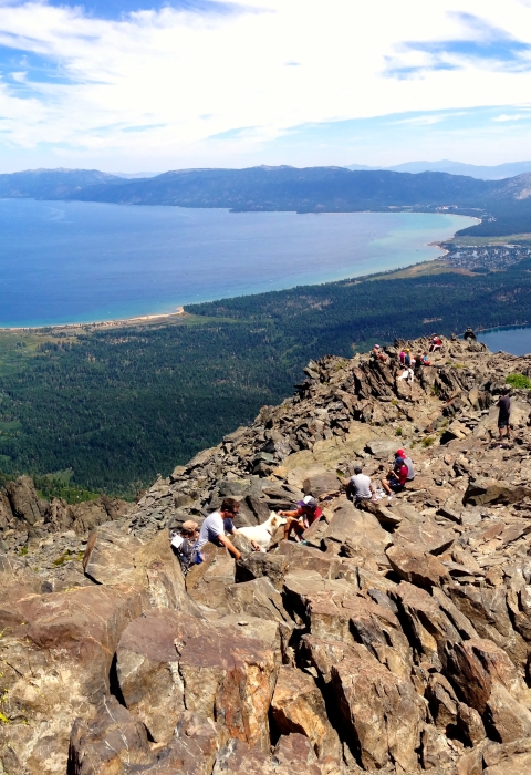a landscape shot of rock covered hills with a body of water in the background
