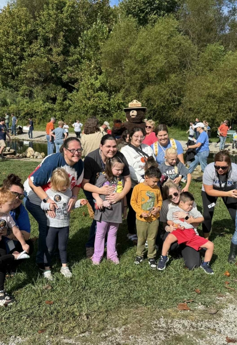 Group of kids smiling in front of stream