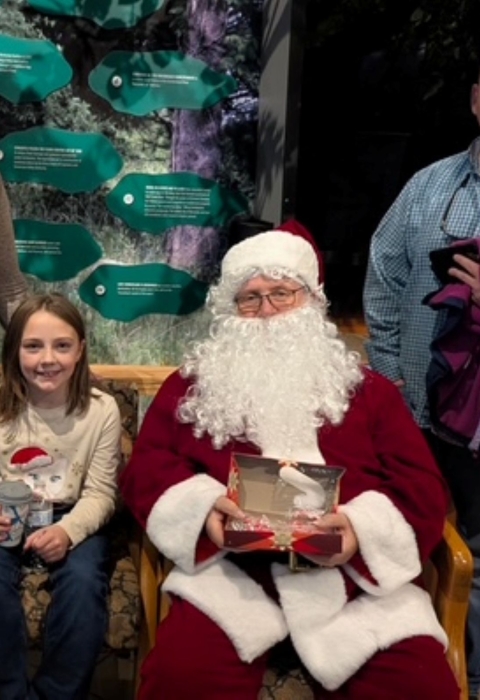Family posing for a photo with Santa