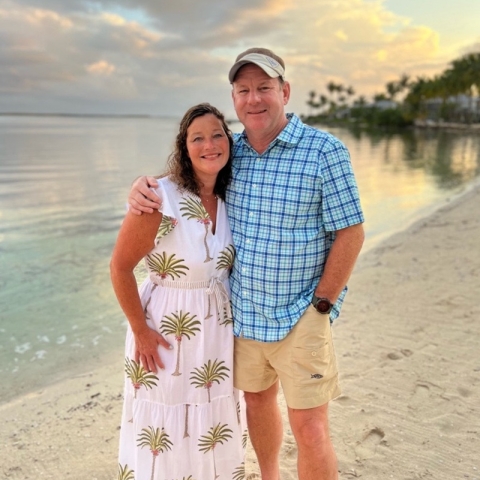 Jeff and his wife standing on the beach