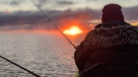 a kayaker on Lake Superior at sunrise