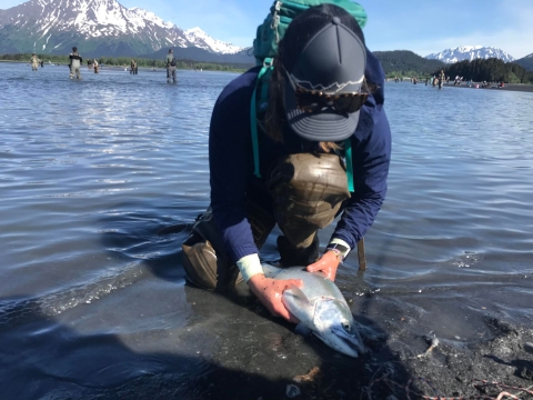 woman holding a fish
