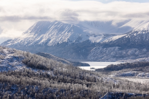 mountains and a lake with snow atop