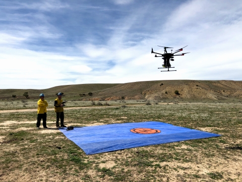 Two employees working with a drone