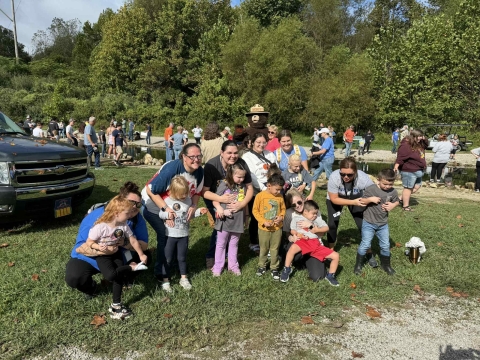 Group of kids smiling in front of stream