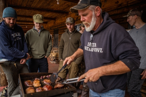 Man grilling waterfowl meat