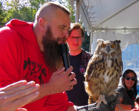 Presenter displays owl to audience