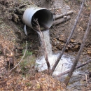 A perched culvert that runs under a road had been placed where fish or other aquatic species would need to drop several feet to reach the water below. A perched culvert is not fish-friendly.  