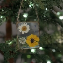Homemade pressed flower ornament on tree