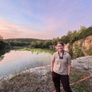 Kris Budd, a U.S. Fish and Wildlife Biologist, stands above a bluff overlooking a pond