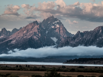 Clouds surround the major peaks of the Teton Range over Jackson Lake and Willow Flats.