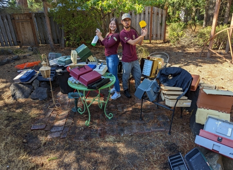 Service interns pose with cleaning gear and over 20 used tackle boxes they cleaned out.